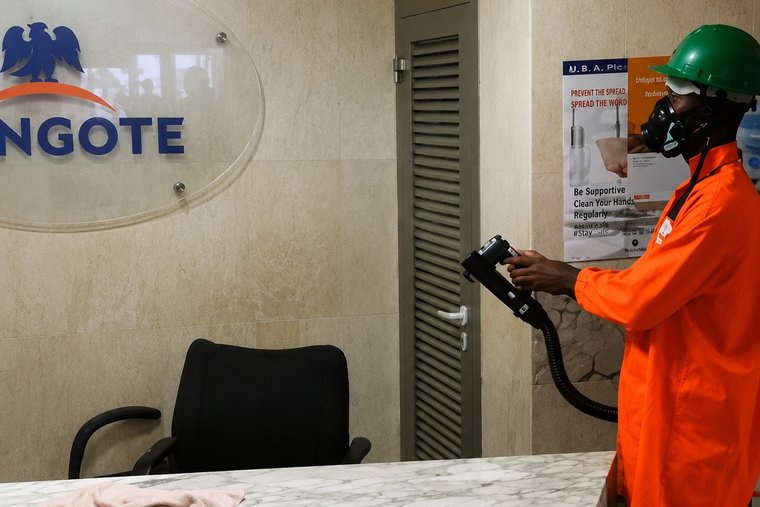 Technician disinfecting a corporate office reception area